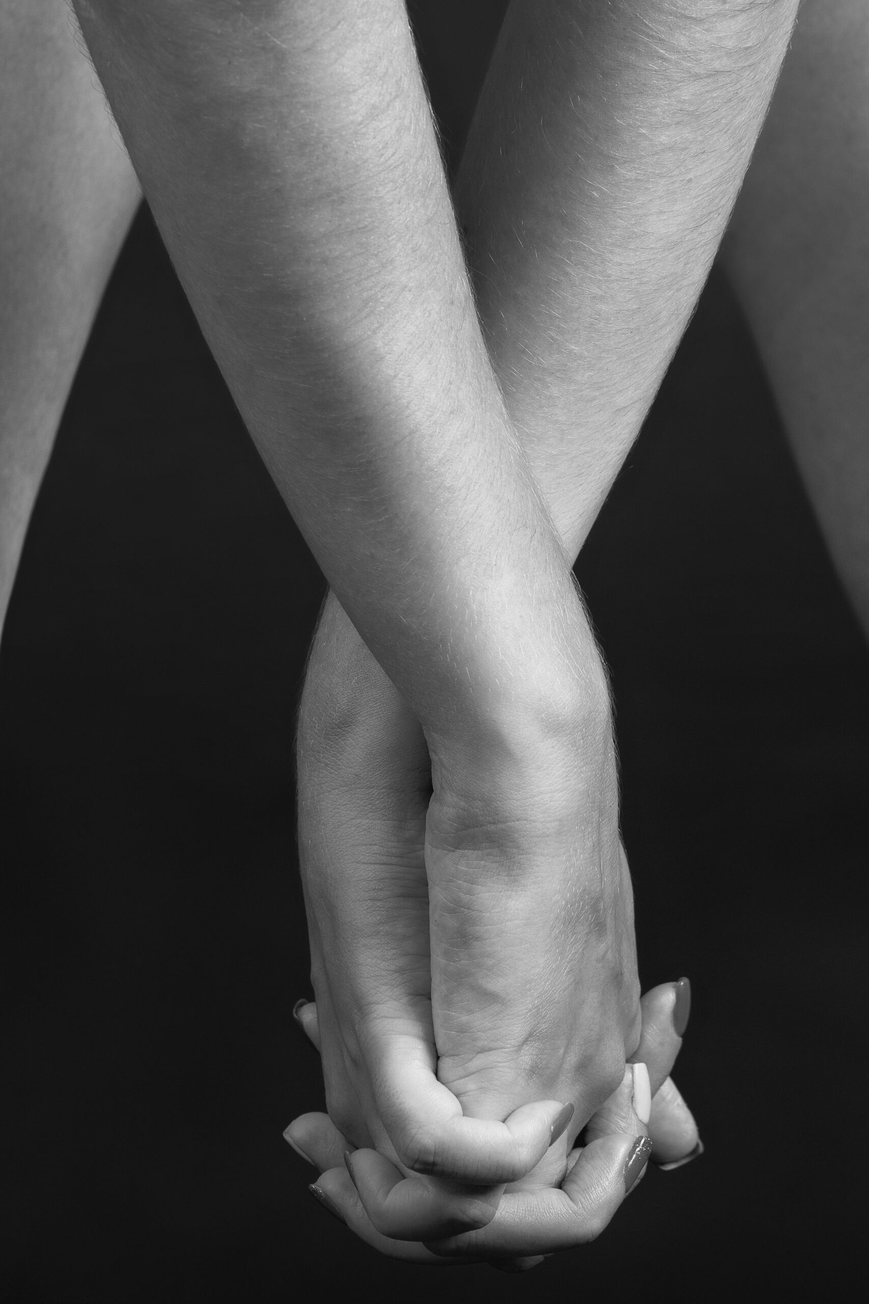 Vertical grayscale shot of female hands in attractive position